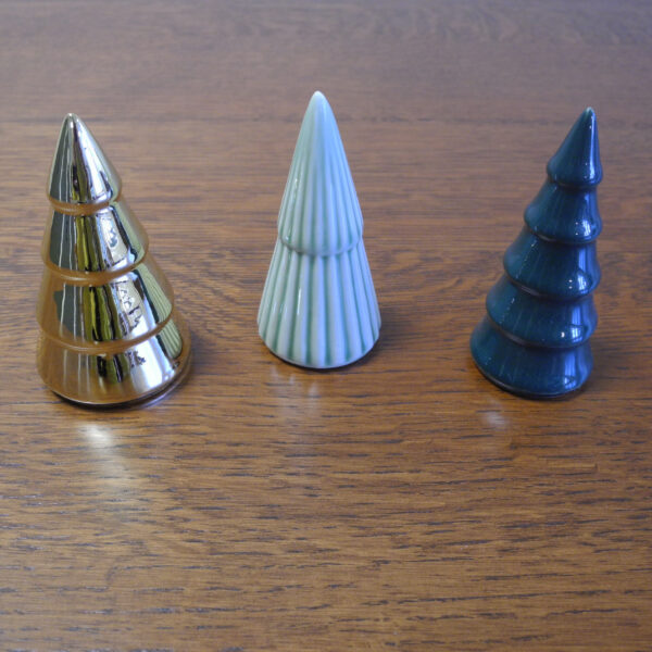 This image shows a trio of porcelain trees. One is a shiny gold. One is light green with vertical stripes. While the last is dark green with no pattern.